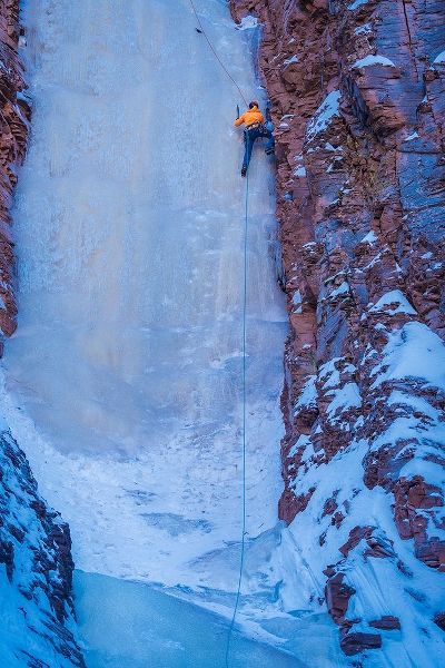 Minnesota-Lake Superior Climber scaling frozen waterfall on cliff